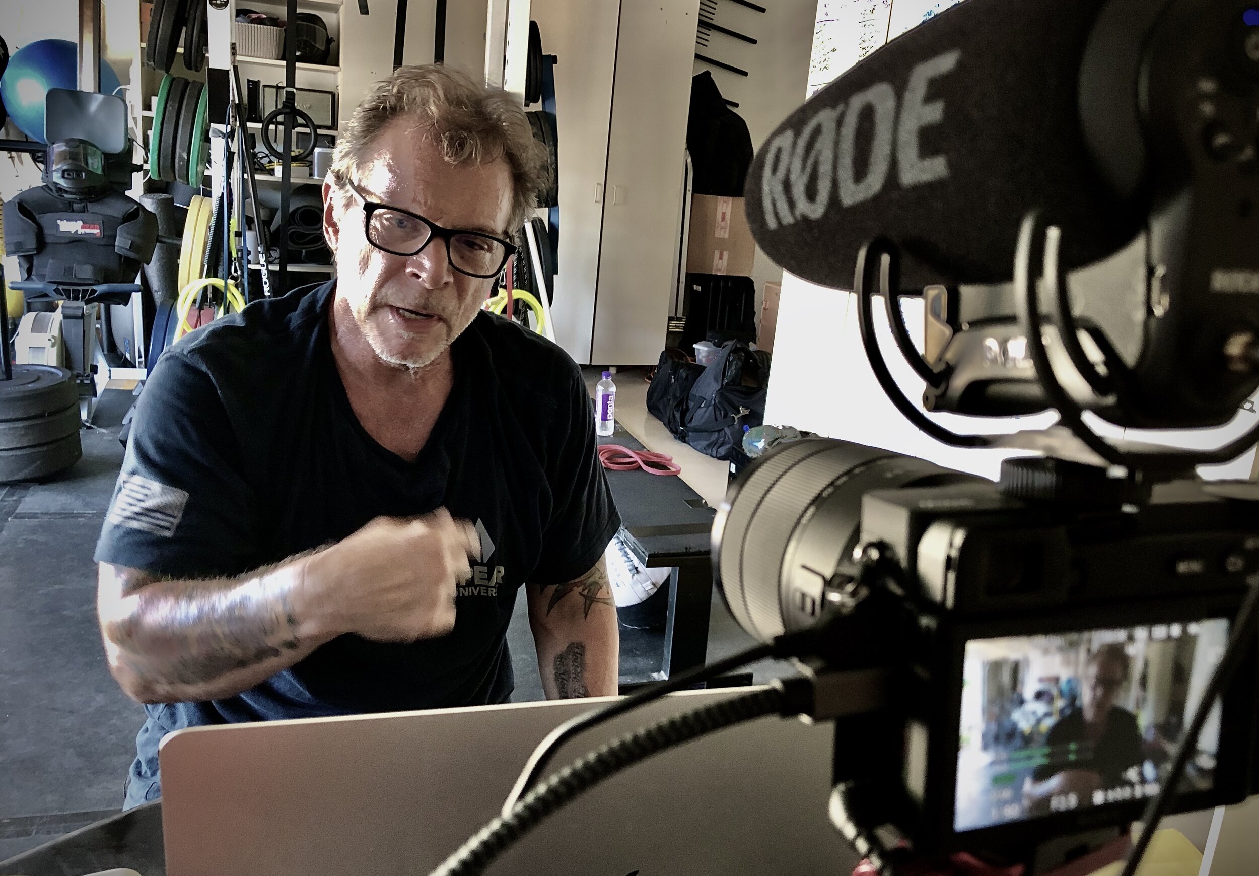 Coach Tony Blauer filming a lesson straight to camera in his garage gym